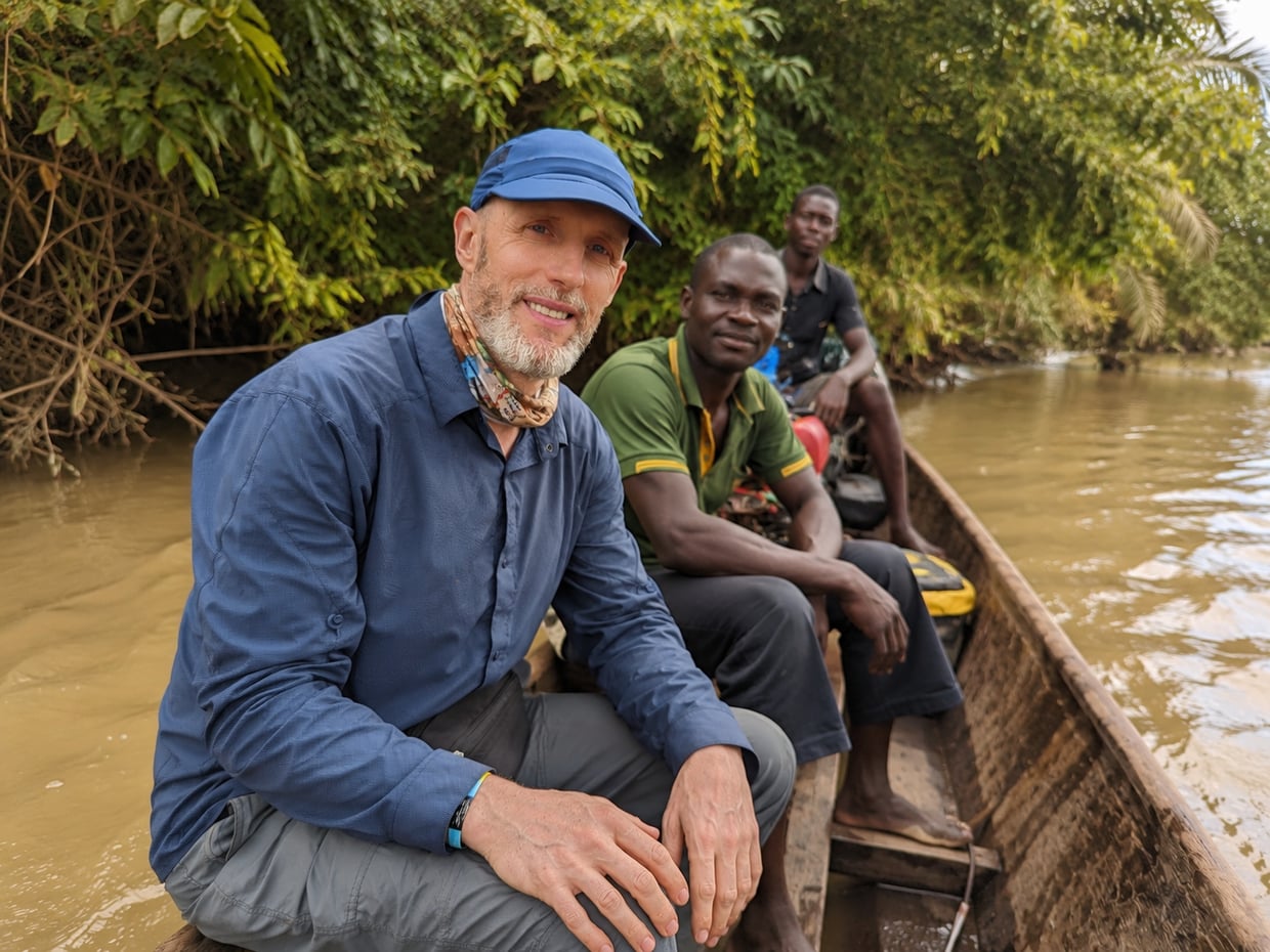 Travelling by wooden dugout canoe along a jungle river with local guides